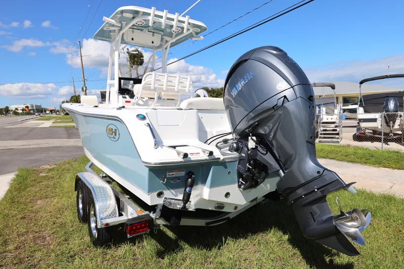 Slide: The Image of 2026 Sea Hunt Ultra 229 boat with Yamaha outboard motor on a trailer, parked outdoors. - 21