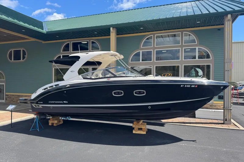Slide: The Image of 2017 Chaparral 337 SSX boat displayed outdoors near a building. - 0