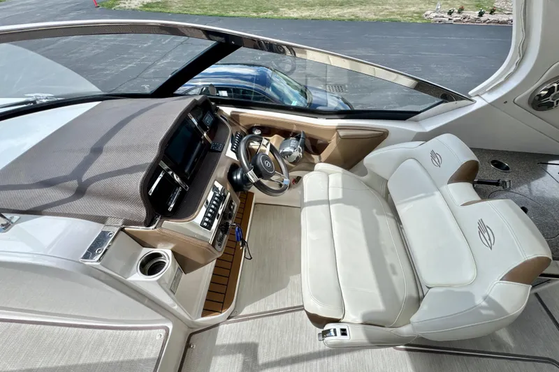 Slide: The Image of 2017 Chaparral 337 SSX boat interior with modern dashboard and plush seating. - 10
