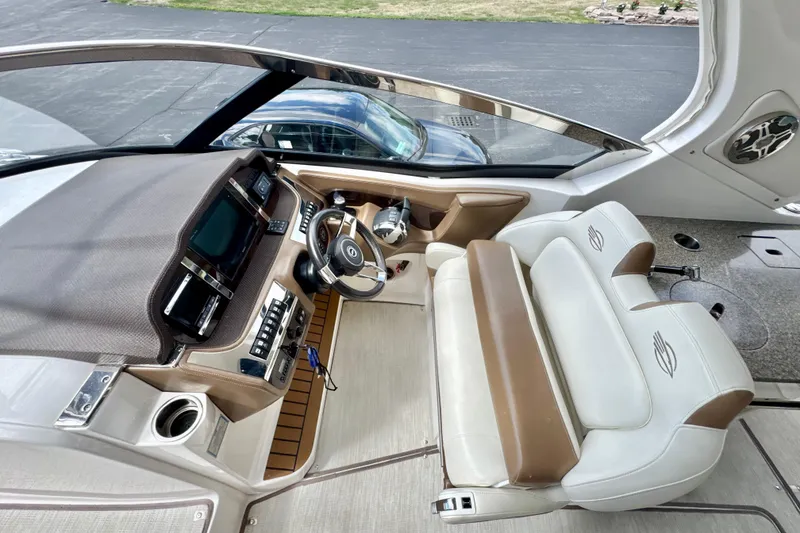 Slide: The Image of 2017 Chaparral 337 SSX boat interior with modern dashboard and plush seating. - 11