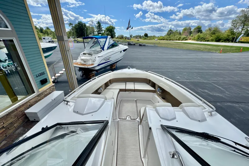 Slide: The Image of 2017 Chaparral 337 SSX boat on display at a marina with clear skies. - 14