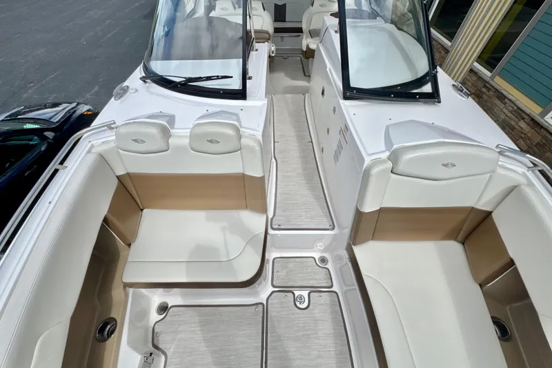 Slide: The Image of 2017 Chaparral 337 SSX boat interior with white and tan seating. - 18
