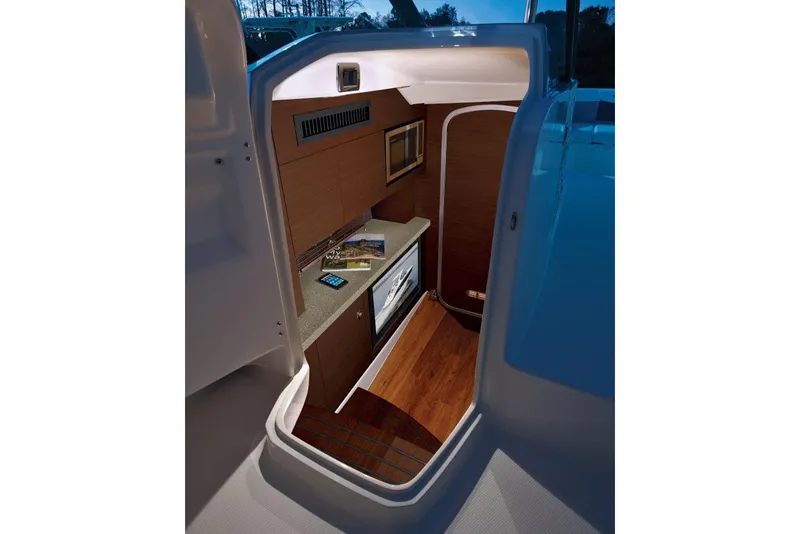 Slide: The Image of Manufacturer Provided Image: 2017 Chaparral 337 SSX cabin interior with kitchenette and wood flooring. - 20