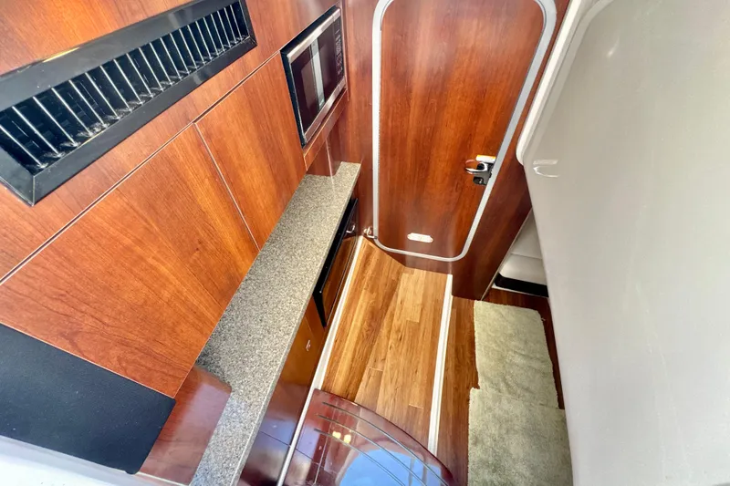 Slide: The Image of Interior of 2017 Chaparral 337 SSX boat with wood finish and modern amenities. - 21