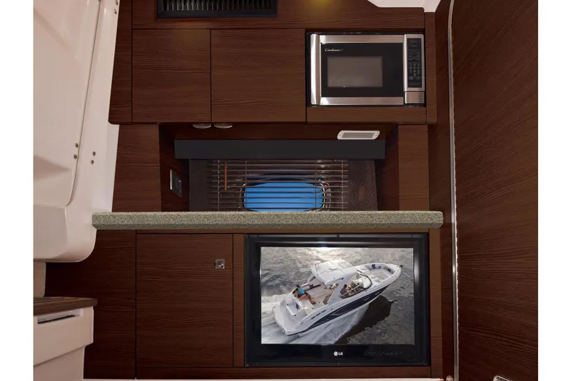 Slide: The Image of Manufacturer Provided Image: 2017 Chaparral 337 SSX boat interior with microwave, TV, and countertop. - 24