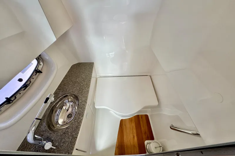 Slide: The Image of 2017 Chaparral 337 SSX boat bathroom with sink, countertop, and wooden flooring. - 27