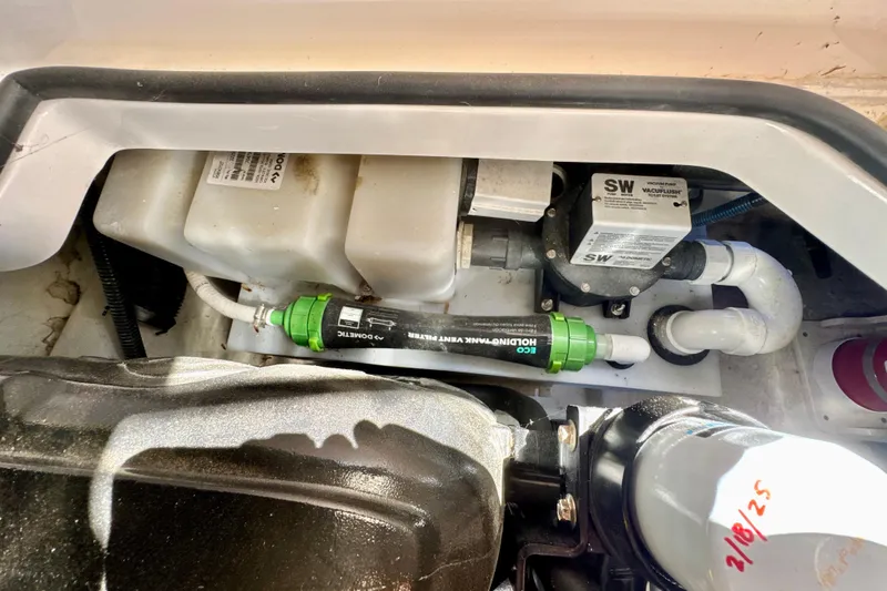 Slide: The Image of Engine compartment of 2017 Chaparral 337 SSX boat, featuring plumbing and filtration system. - 34