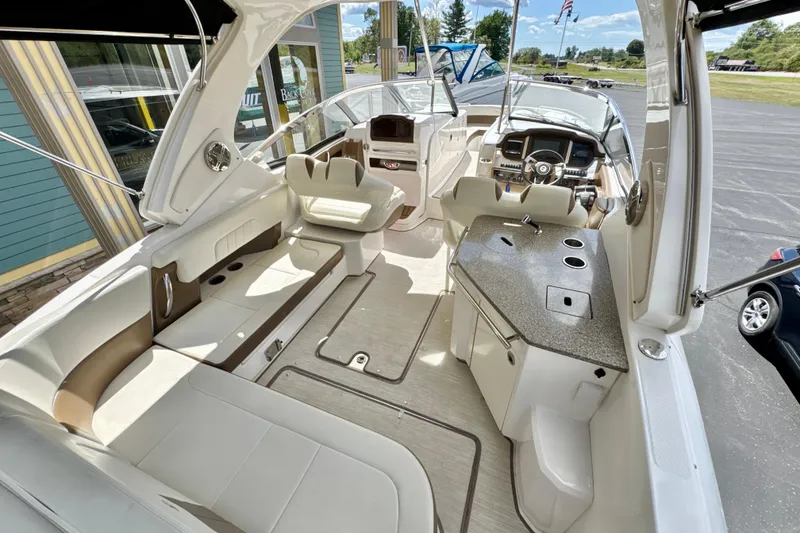 Slide: The Image of 2017 Chaparral 337 SSX boat interior with seating, helm, and kitchenette. - 6