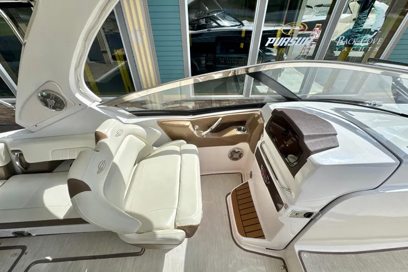 Slide: The Image of 2017 Chaparral 337 SSX boat interior with luxurious seating and modern dashboard. - 9