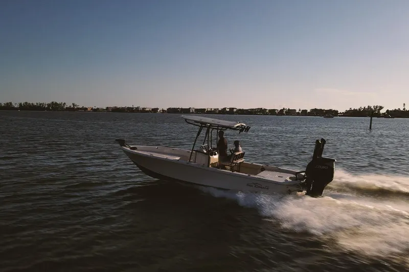 Slide: The Image of 2021 Sea Chaser 26 LX boat cruising on open water at sunset. - 1