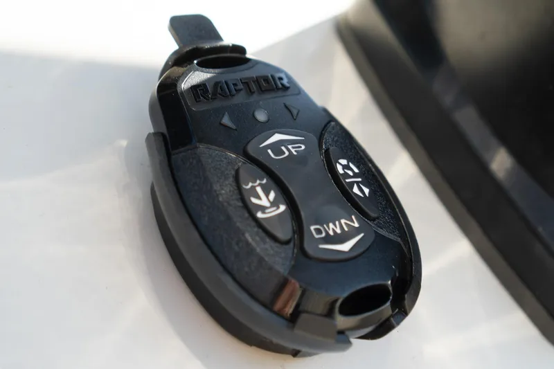 Slide: The Image of Remote control for Sea Chaser 26 LX 2021 boat, featuring "UP" and "DWN" buttons. - 10