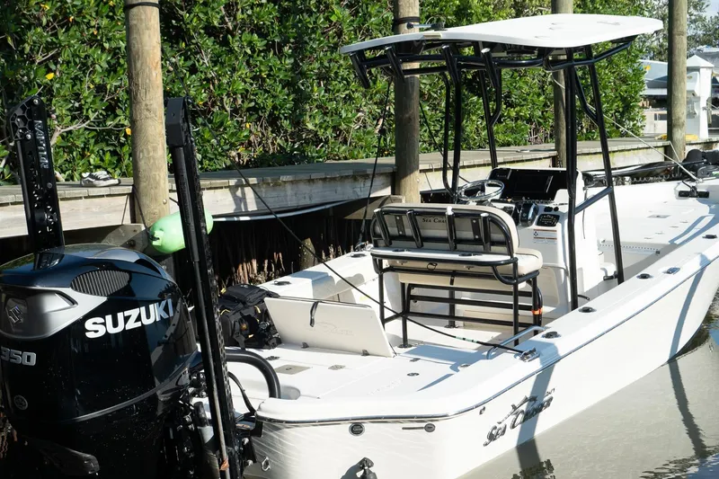 Slide: The Image of 2021 Sea Chaser 26 LX boat docked, featuring Suzuki engine and sleek design. - 12