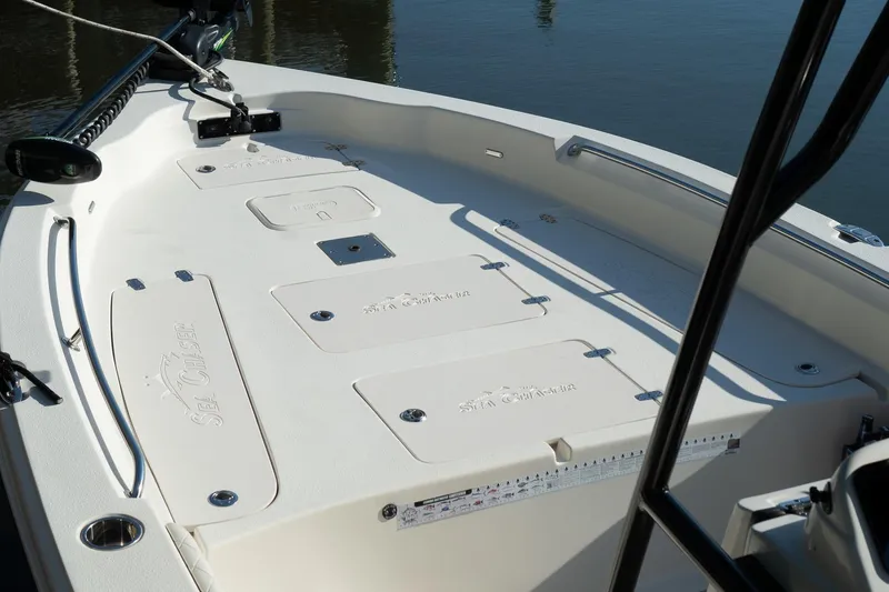 Slide: The Image of 2021 Sea Chaser 26 LX boat deck with storage compartments and fishing rod holders. - 18
