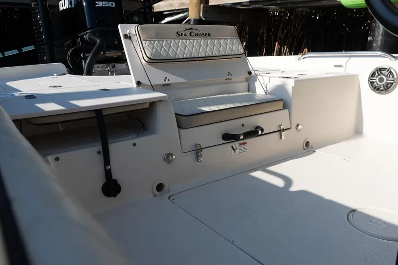 Slide: The Image of 2021 Sea Chaser 26 LX boat interior with seating and storage compartments. - 22