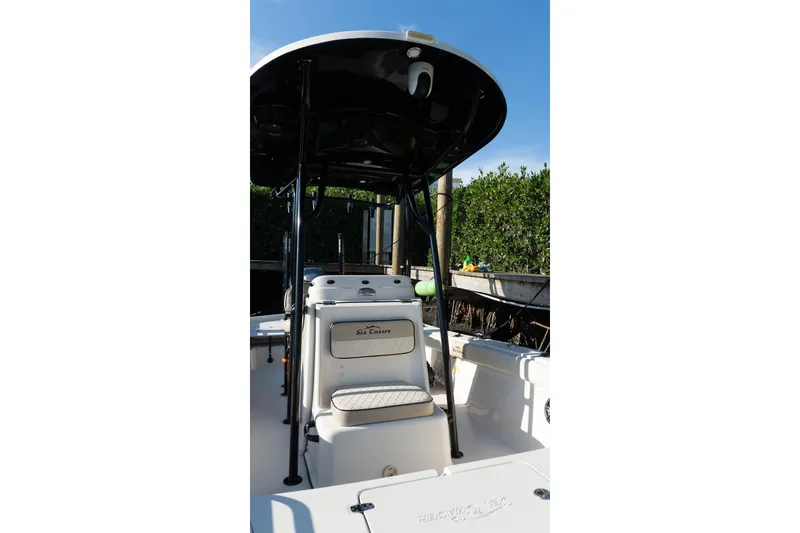 Slide: The Image of 2021 Sea Chaser 26 LX boat interior with T-top and seating. - 27