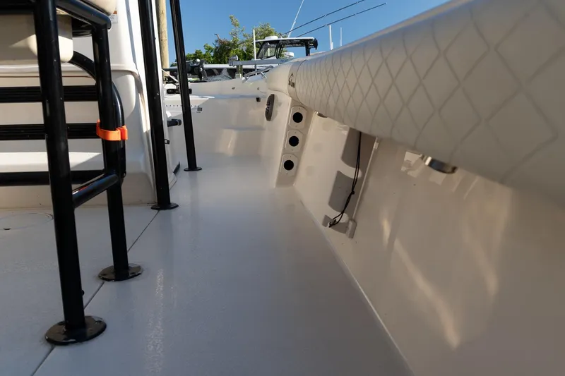 Slide: The Image of 2021 Sea Chaser 26 LX boat interior with seating and rod holders. - 29