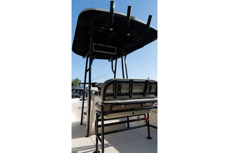 Slide: The Image of 2021 Sea Chaser 26 LX boat with T-top and rod holders, viewed from the rear. - 33