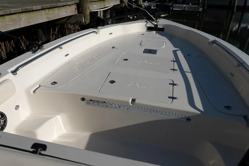 Slide: The Image of 2021 Sea Chaser 26 LX boat deck with storage compartments and railing. - 34