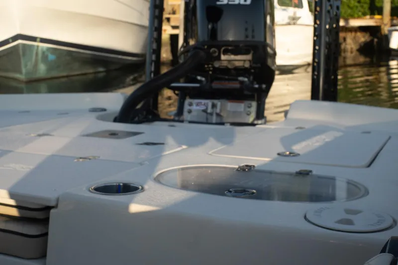 Slide: The Image of 2021 Sea Chaser 26 LX boat deck with engine, docked in marina. - 38