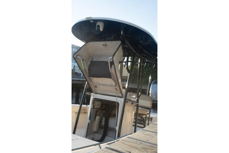 Slide: The Image of 2021 Sea Chaser 26 LX boat with T-top and seating, docked at marina. - 39