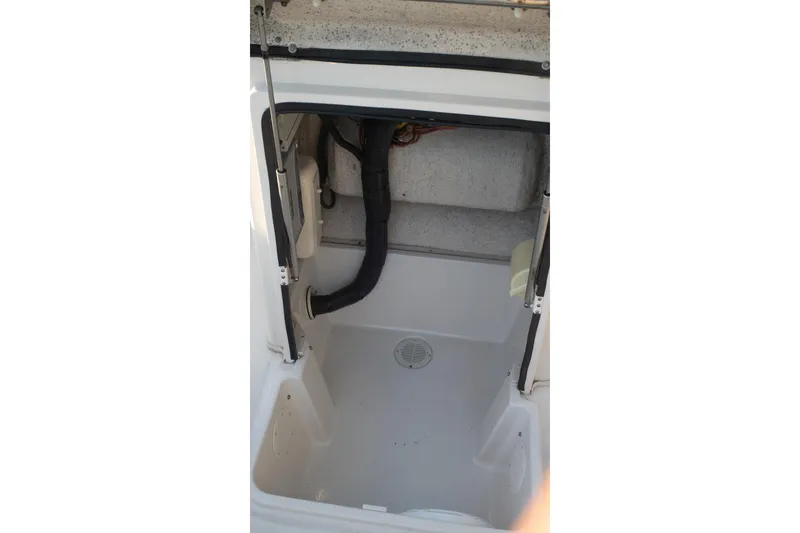Slide: The Image of 2021 Sea Chaser 26 LX boat interior compartment with drainage and wiring. - 40
