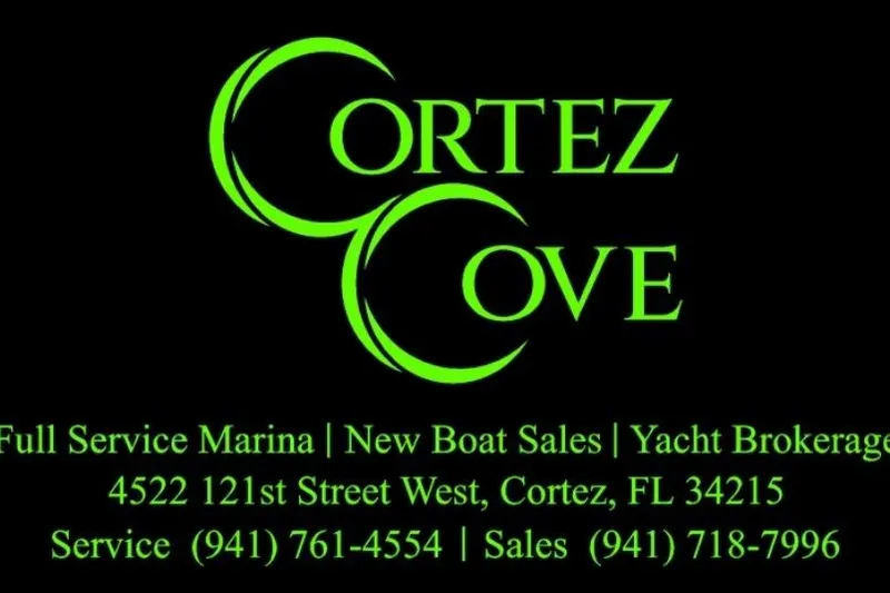 Slide: The Image of Cortez Cove marina advertisement with contact details and services in green text. - 44