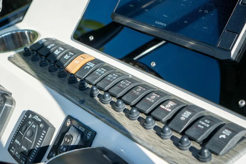 Slide: The Image of Control panel of 2021 Sea Chaser 26 LX boat with switches and Garmin display. - 6