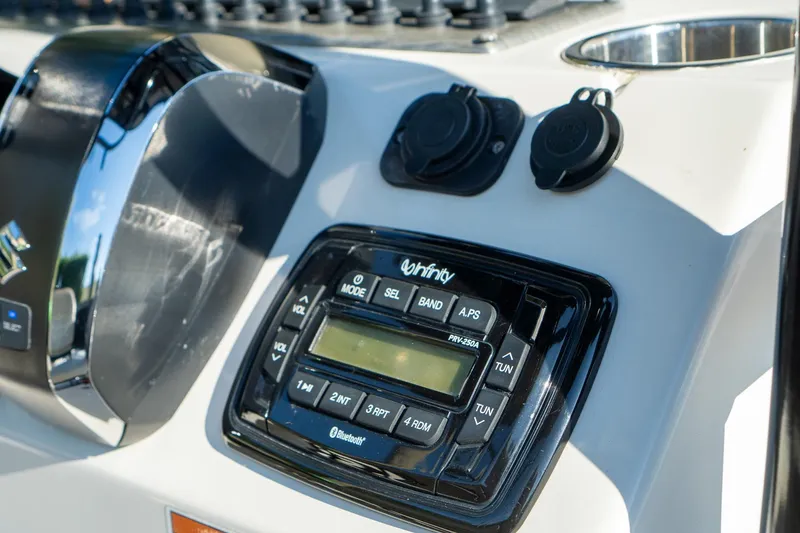 Slide: The Image of 2021 Sea Chaser 26 LX boat dashboard with Infinity stereo system and controls. - 8