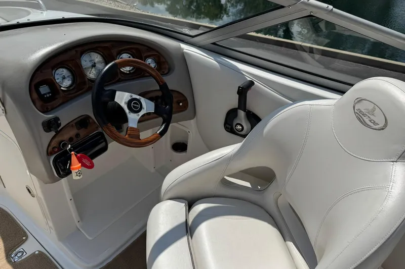 Slide: The Image of 2006 Ebbtide 2100 Bow Rider boat interior with steering wheel and dashboard controls. - 10