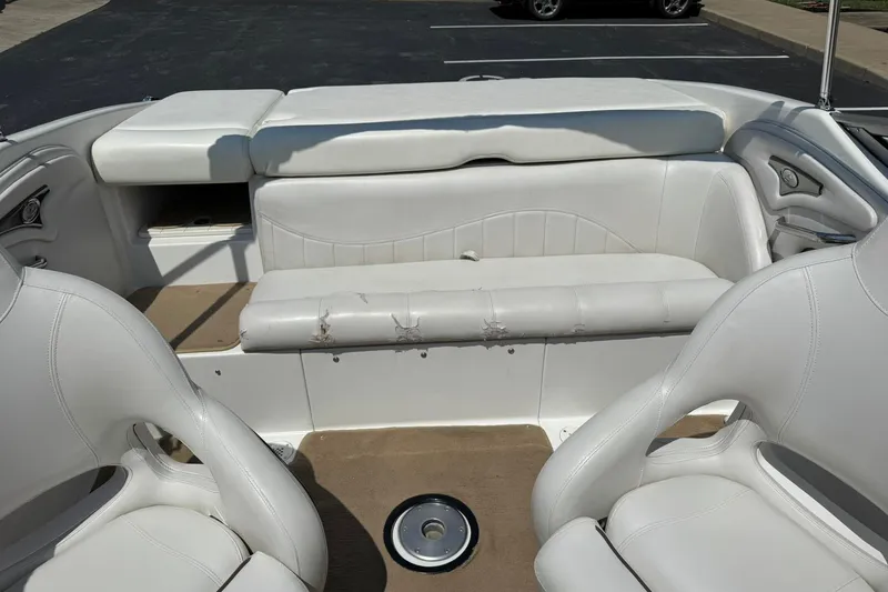 Slide: The Image of 2006 Ebbtide 2100 Bow Rider interior with white seating and beige flooring. - 11