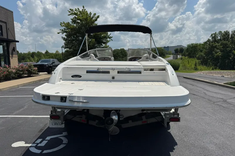 Slide: The Image of 2006 Ebbtide 2100 Bow Rider boat parked in a sunny lot, rear view. - 4