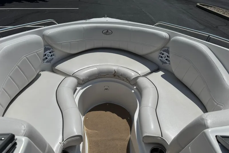 Slide: The Image of 2006 Ebbtide 2100 Bow Rider boat interior with white seating and speakers. - 7
