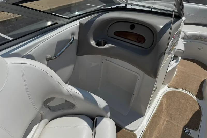 Slide: The Image of 2006 Ebbtide 2100 Bow Rider interior with white seating and dashboard details. - 9