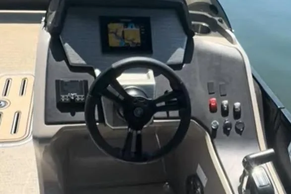 Slide: The Image of 2023 Premier Sunsation boat dashboard with steering wheel and control panel. - 11