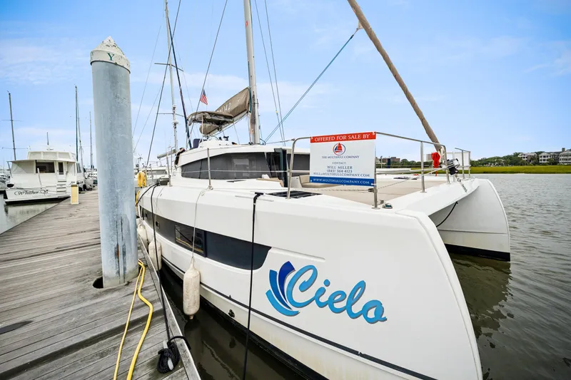 Slide: The Image of 2023 Bali 4.2 catamaran "Cielo" docked, for sale, with clear blue sky background. - 10