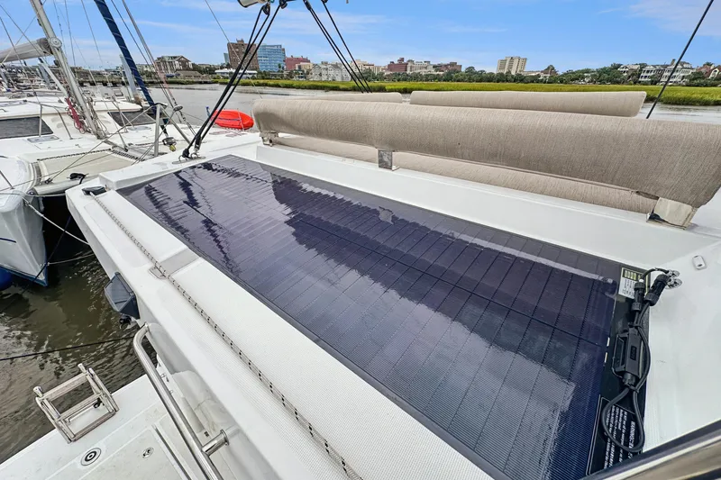 Slide: The Image of 2023 Bali 4.2 catamaran with solar panel on deck, docked in a marina. - 102