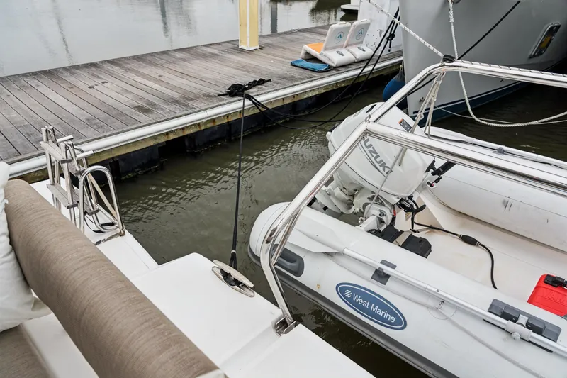 Slide: The Image of Docked Bali 4.2 boat with Suzuki outboard motor and West Marine inflatable, 2023 model. - 105
