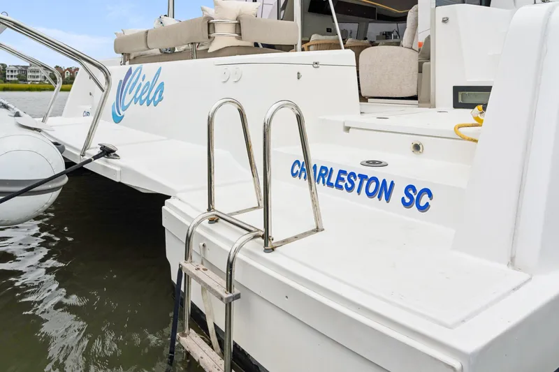 Slide: The Image of 2023 Bali 4.2 yacht docked, featuring "Cielo" and "Charleston SC" text on the stern. - 106
