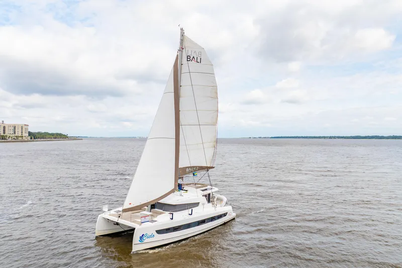 Slide: The Image of Sailing catamaran Bali 4.2, 2023 model, cruising on open water under cloudy skies. - 108