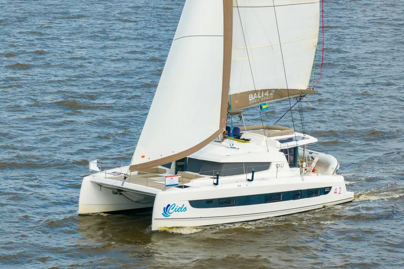 Slide: The Image of 2023 Bali 4.2 catamaran sailing on open water, showcasing sleek design and spacious deck. - 116