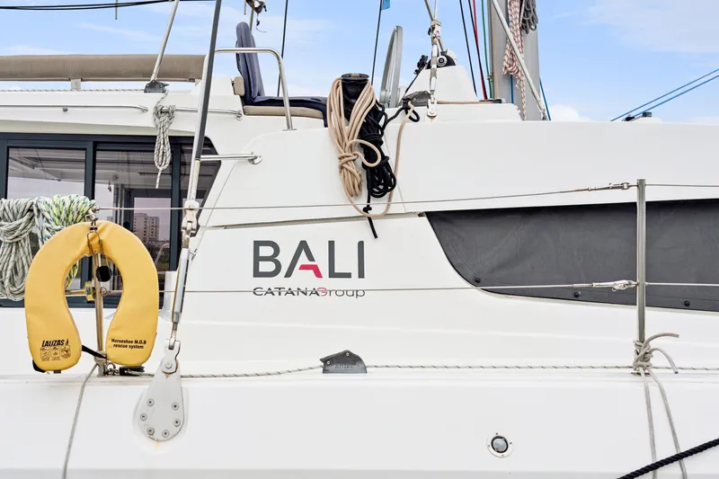 Slide: The Image of 2023 Bali 4.2 catamaran side view with safety equipment and ropes. - 12