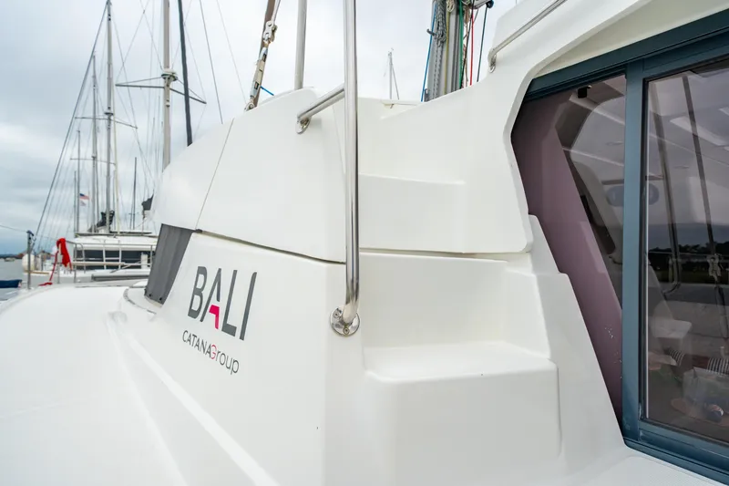 Slide: The Image of 2023 Bali 4.2 catamaran by Catana Group, docked with visible branding. - 13