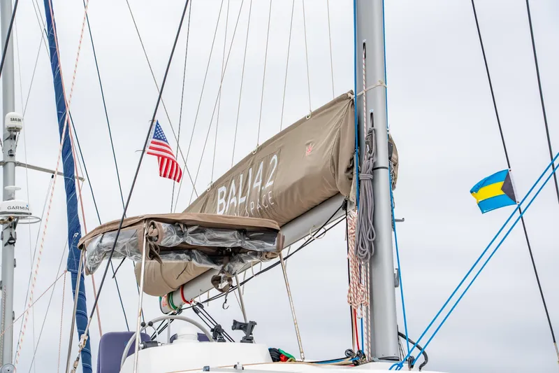 Slide: The Image of Sailboat Bali 4.2 (2023) with American and Bahamian flags, mast and rigging visible. - 15