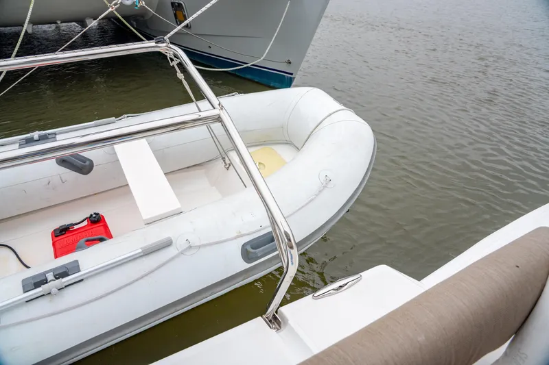 Slide: The Image of Inflatable dinghy beside Bali 4.2 catamaran, 2023 model, on calm water. - 16