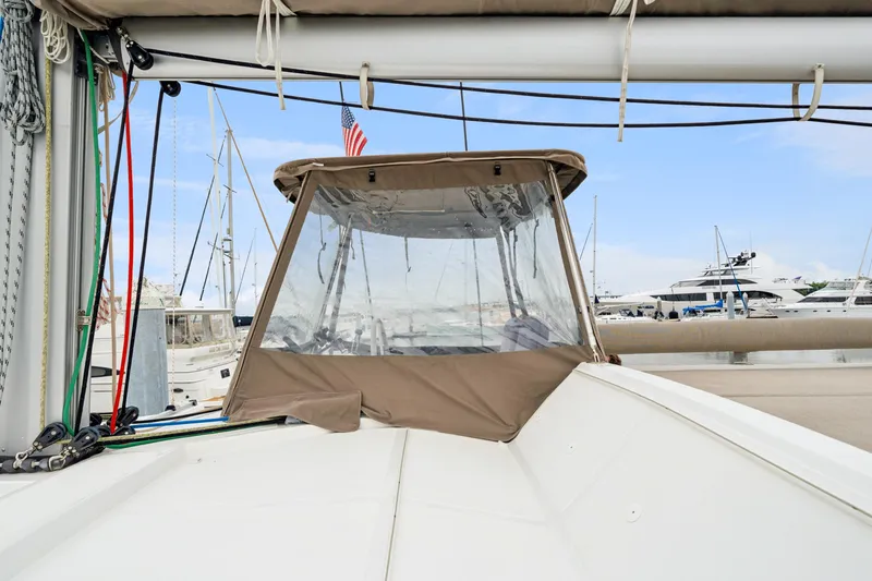 Slide: The Image of 2023 Bali 4.2 yacht with covered cockpit, docked in marina with other boats. - 18