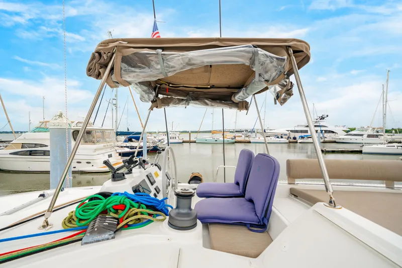 Slide: The Image of 2023 Bali 4.2 yacht interior with seating, ropes, and marina view. - 19