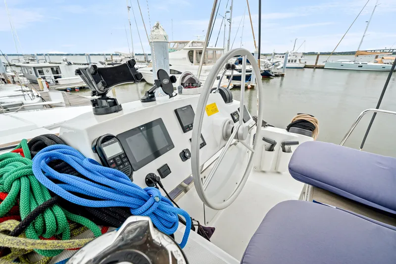 Slide: The Image of Cockpit of 2023 Bali 4.2 yacht with steering wheel and navigation equipment in marina. - 20