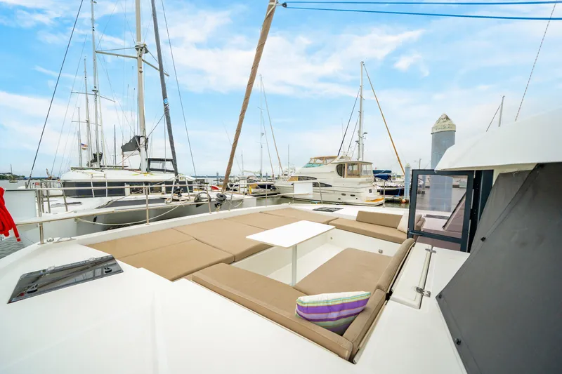 Slide: The Image of Modern Bali 4.2 catamaran, 2023 model, docked at marina with spacious seating area. - 24