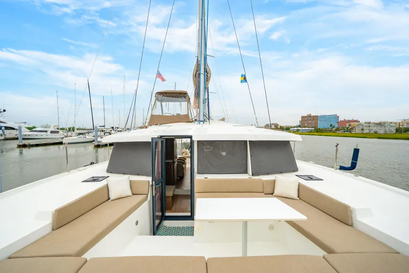 Slide: The Image of 2023 Bali 4.2 catamaran with spacious deck, docked in a marina under a blue sky. - 26