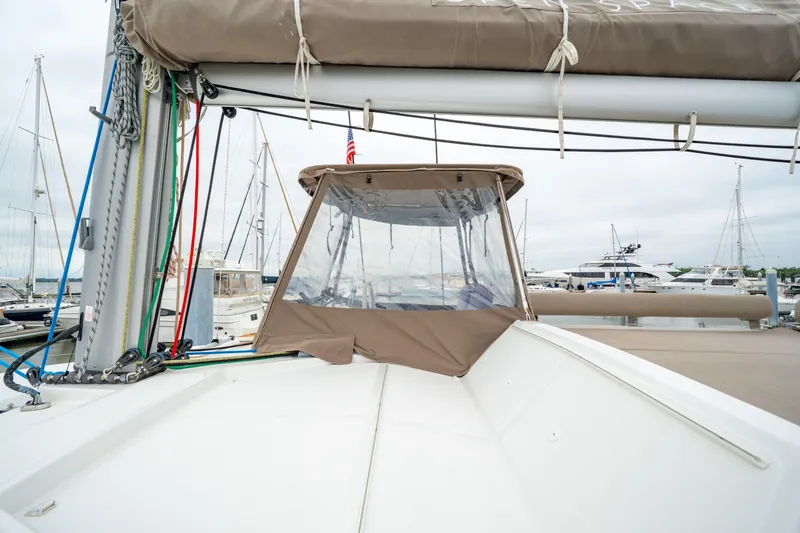 Slide: The Image of 2023 Bali 4.2 yacht with covered cockpit, docked at marina with sailboats. - 30